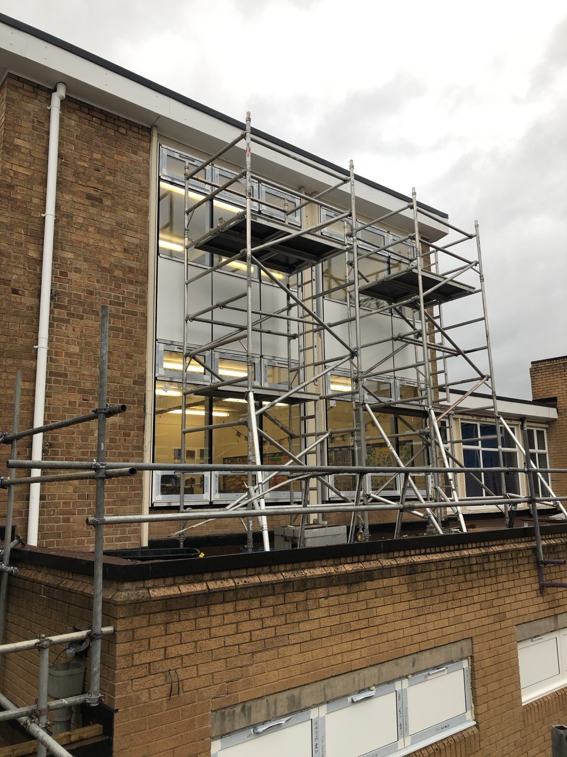 Large commercial window and door installation in a brick building, photographed by Kingfisher